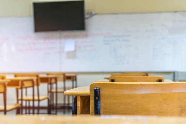 istock Back to school concept. School empty classroom, Lecture room with desks and chairs iron wood for studying lessons in highschool thailand without young student, interior of secondary education 1171931394