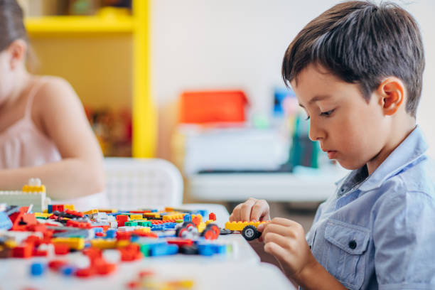 istock Young boy playing with toy cubes 1171932523