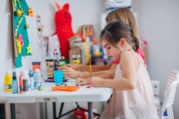 istock Two girls painting on art class 1171933760