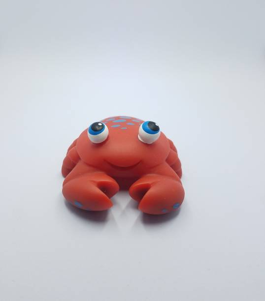istock red plastic toy crab on white background 1171938641
