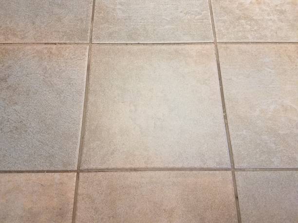 istock dirty grey square tiles on the floor 1171939245