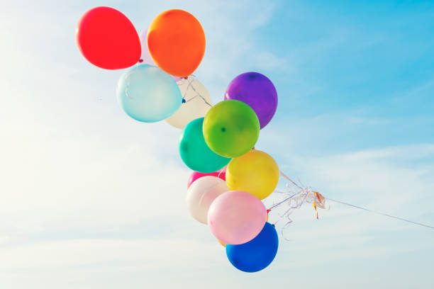 istock Multi color balloons with canvas bed for relax on sunset tropical beach sunny day. Summer Concept. 1171939443