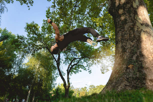 istock Parkour athlete doing backflip in nature 1171946056