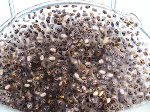 above view of chia seeds absorbed water and made mucilage substance close-up in glass