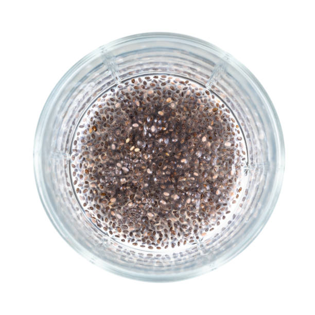 chia seeds made beverage with gelatinous texture top view of chia seeds absorbed water and made a beverage with gelatinous texture at bottom of glass beaker cutout on white background salvia hispanica plant stock pictures, royalty-free photos & images
