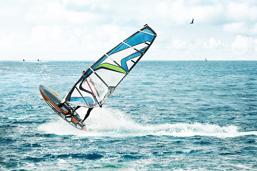 People practicing kitesurfing on the beach of Los Caños de Meca, next to the Trafalgar Lighthouse, Barbate, Cádiz