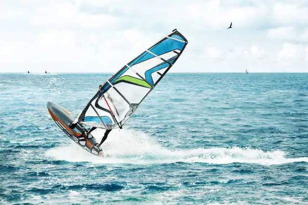 Windsurfer, fun in the blue ocean with waves