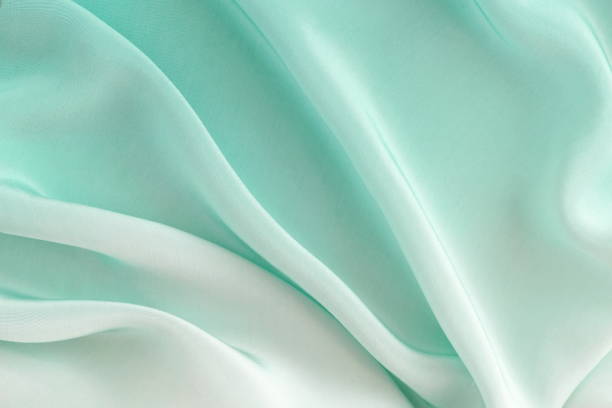 istock silk fabric texture, background  pastel neo mint color . copy space 1171948321