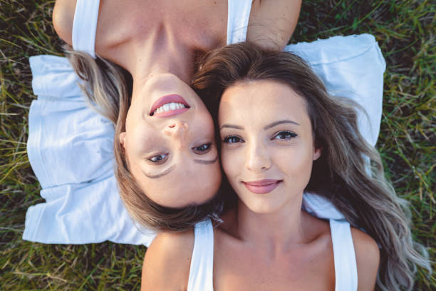istock Two girls lying on the grass 1171948590