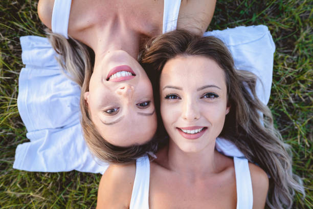 istock Two girls lying on the grass 1171948811