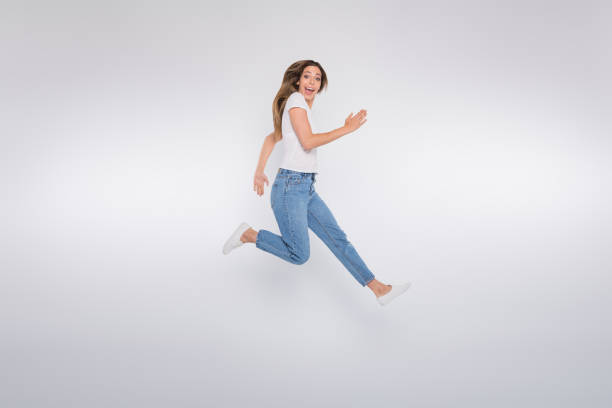 istock Full length body size photo of girlfriend running forward looking into camera while isolated with white background 1171948876