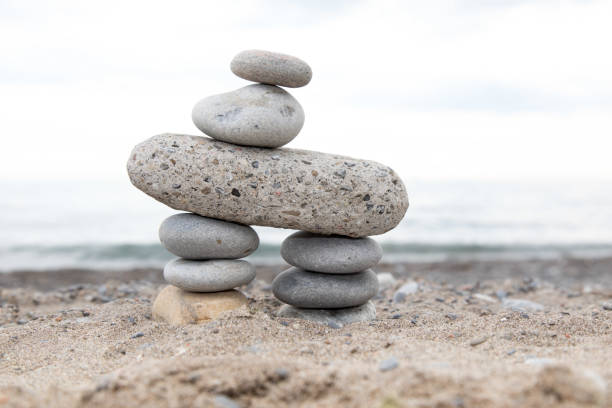istock stone tower stacked on a beach as a cairn or marker 1171949962