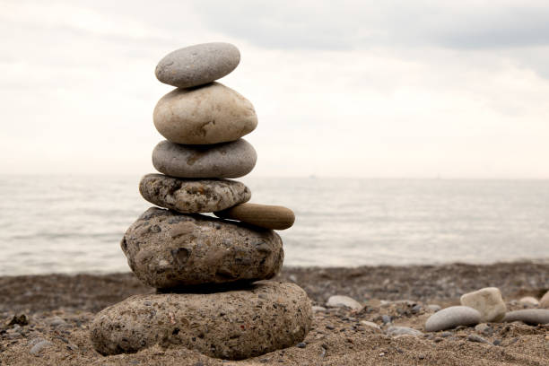 istock stone tower stacked on a beach as a cairn or marker 1171950080