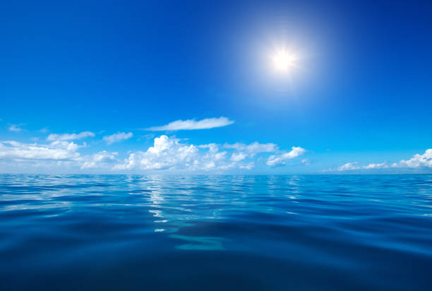 istock clouds on blue sky over calm sea with sunlight reflection 1171953273