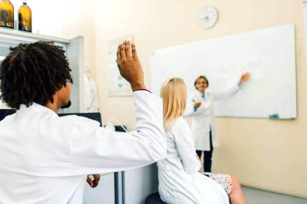 istock Science students and lecturer looking at whiteboard 1171954615