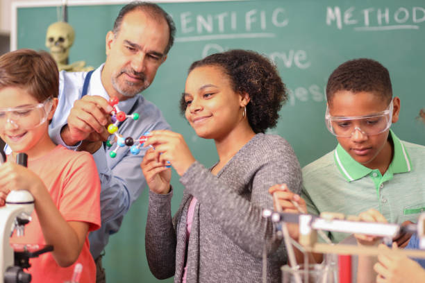 istock Junior high age school students conduct science experiments in classroom. 1171954968
