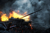 Burning battle tank on the battlefield at dusk