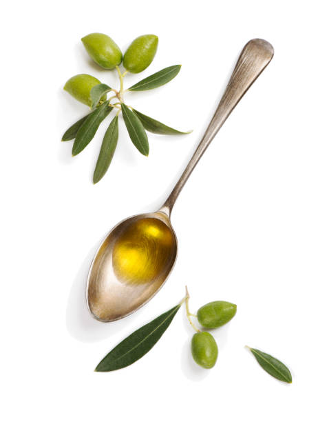 Olive fruit and spoon with olive oil.