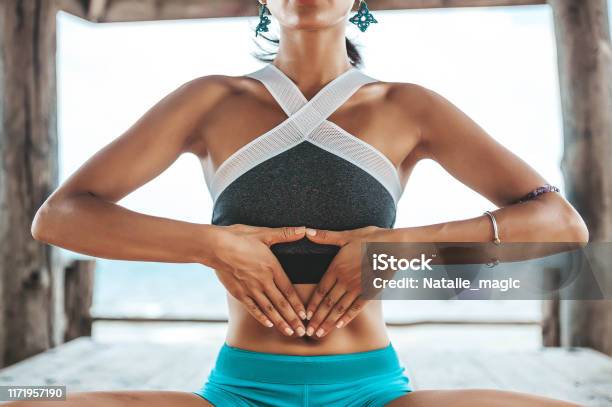 Young Woman Doing Yoga In The Wooden Gazebo At The Beach Stock Photo - Download Image Now