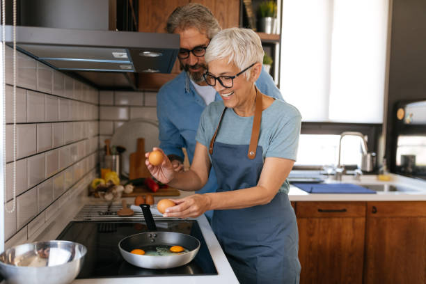 they've got the perfect recipe for love - cooking senior adult healthy lifestyle couple imagens e fotografias de stock