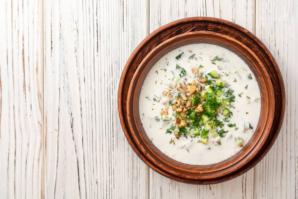 istock Traditional bulgarian cold summer soup tarator with yogurt, dill, cucumber and walnuts in ceramic bowl on wooden table 1171958986