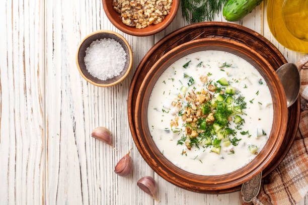 istock Traditional bulgarian cold summer soup tarator with yogurt, dill, cucumber and walnuts in ceramic bowl on wooden table 1171959018