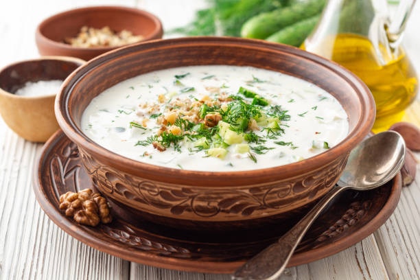 istock Traditional bulgarian cold summer soup tarator with yogurt, dill, cucumber and walnuts in ceramic bowl on wooden table 1171959027