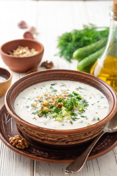 istock Traditional bulgarian cold summer soup tarator with yogurt, dill, cucumber and walnuts in ceramic bowl on wooden table 1171959038