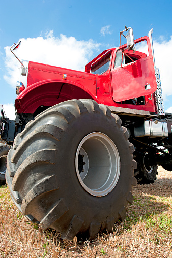 Big Foot monster truck close up, showing the huge wheels and tyres with chunky tread pattern that gives high-rise effect to the vehicle cab of this impractical but fun transport, England, UK