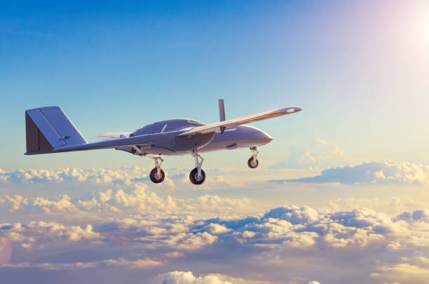 Unmanned military aircraft reconnaissance uav patrolling the evening at sunset sky clouds. Unmanned military aircraft reconnaissance uav patrolling the evening at sunset sky clouds remote controlled stock pictures, royalty-free photos & images