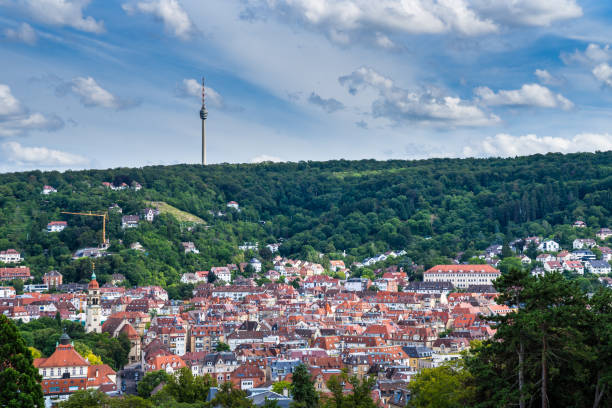 Germany, Cityscape stuttgart of red roofs of houses in basin surrounded by green forest and decorated with television tower on a hill stock photo