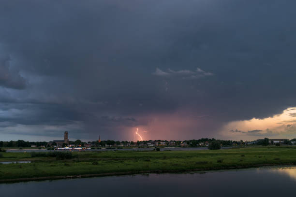 istock Lightning strikes down to earth from an evening thunderstorm over the dutch river landscape 1171962571