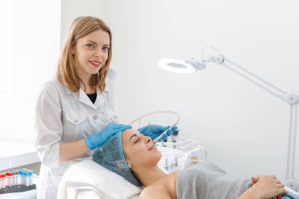 istock Beautician procedure diamond microdermabrasion patient face. A young girl is undergoing a course of spa treatments in the office of a beautician. Moisturizing, cleaning and facial skin care. Cosmetic procedures 1171963740