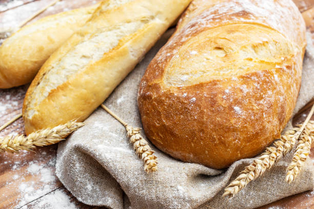 istock Fresh bread with wheat ears on the table. Close up. 1171963942