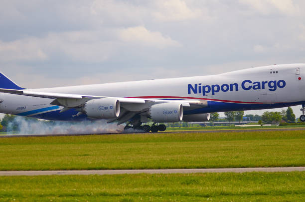 Landing in Amsterdam airport, first touch, Nippon Cargo. Amsterdam, Netherlands - May, 21, 2017, first touch, Nippon Cargo in Amsterdam airport. Plane arrived in the Netherlands by a regular flight, photo has been made from official view spot next Amsterdam Airport. nippon cargo airlines photos stock pictures, royalty-free photos & images
