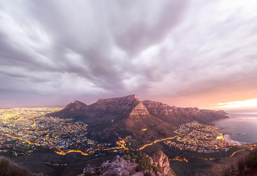 Panoramic view of Table Mountain as seen from on top of Lions Head during beautiful sunset as a storm moves in - Cape Town, South Africa