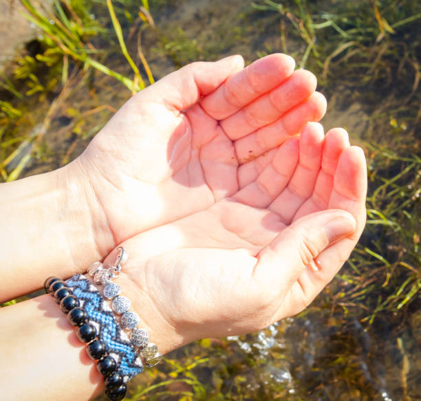istock River water in the palms flows through fingers 1171970291