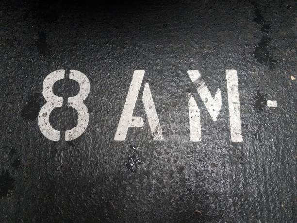 istock eight or 8 AM in white stencil on black asphalt 1171976671