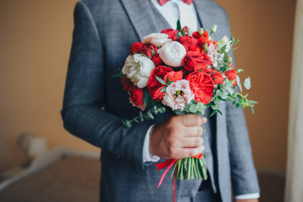 istock Man in a suit with a wedding bouquet... 1171977877