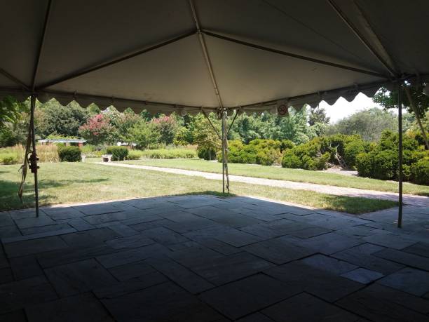 istock grey stone tiles and tent and trees 1171978982