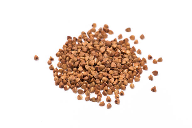 istock raw buckwheat isolated on white background. 1171982359