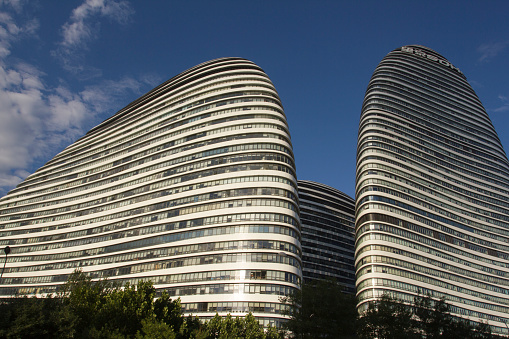 Facade of modern residential towers in a green environment, sustainable buildings