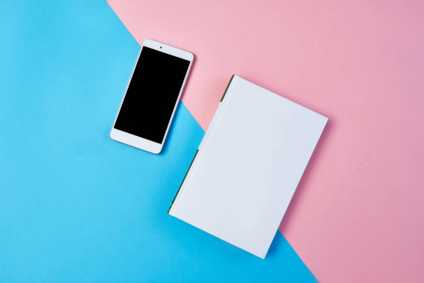 istock Flat lay composition with smartphone and notepad on a blue and pink background. 1171986529