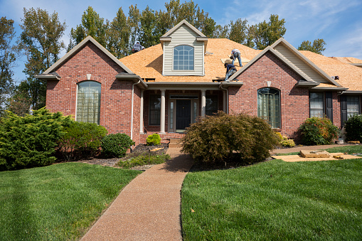 Roofing construction on a part of the new house covered in asphalt shingles