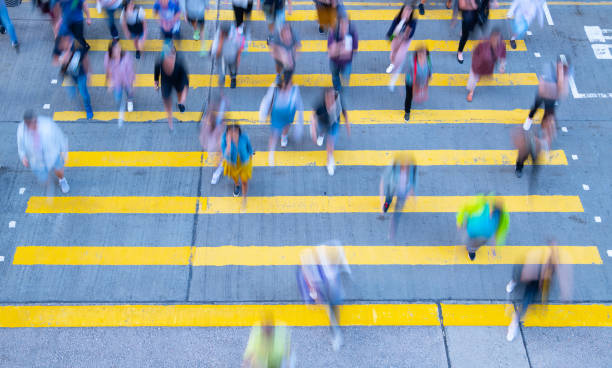 istock Young woman standing out, with phone, in motion blurred crowd 1171987511