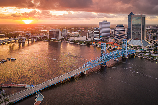 Jacksonville, Florida is bathed in the day's final rays of sunlight in this aerial view of the St. Johns River and downtown skyline.