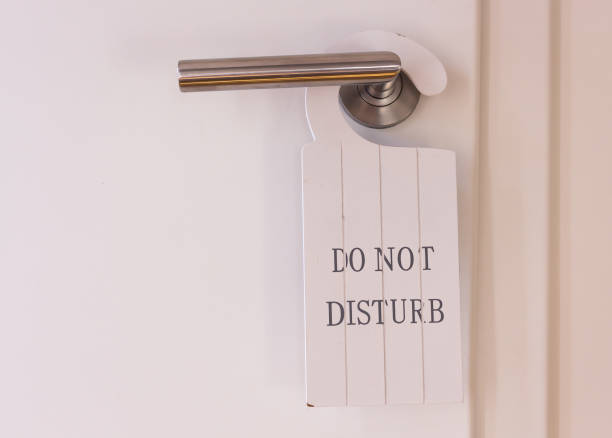 istock white do not disturb sign hanging decoratively on a restroom door. 1171990667
