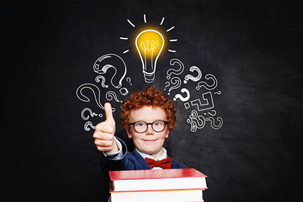istock Happy education and creativity concept. Smiling boy in glasses with books and lightbulb 1171991821