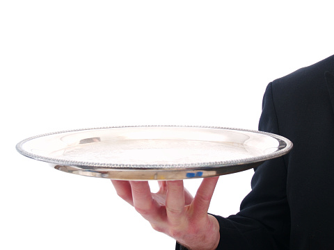 a man waiter holding a silver platter isolated on white.