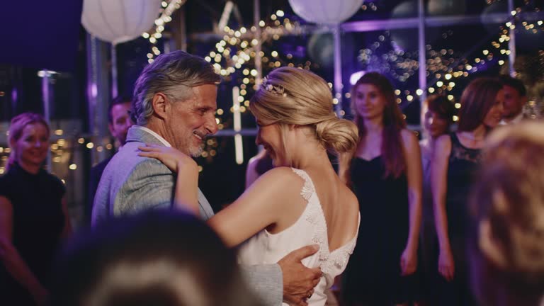 Father and bride doing ballroom dancing in wedding